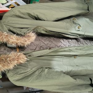 Olive green jacket with snap closure and zipper. Faux-fur hood with fleece.